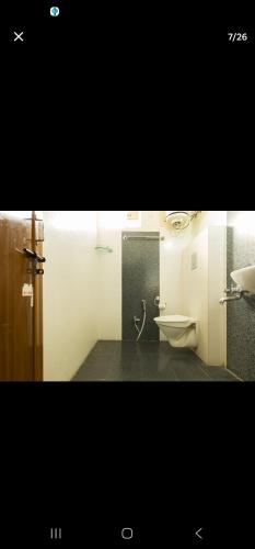 a bathroom with a toilet and a sink at Luxurious 3 bhk apartment in Hyderabad