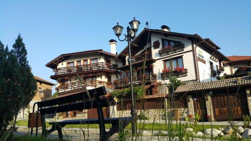 a large building with a street light in front of it at Guest House Dzhangal in Bansko