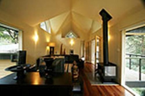 a living room with a fireplace in a house at Lochiel Luxury Accommodation in Olinda