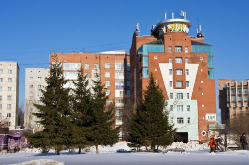 a building with a clock tower on top of it at Sport-Hotel in Tomsk