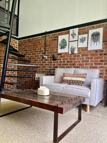 a living room with a couch and a coffee table at Wannik's Homestay in Kota Bharu in Kampong Bukit Kechik