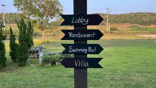 a street sign with arrows pointing in different directions at The Barn Hua Hin in Khao Tao
