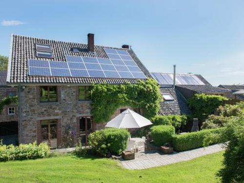 a house with solar panels on the roof at Desnié Farmhouse with Pool in Desnié