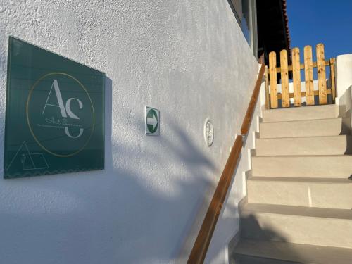 a sign on the side of a building with stairs at Art Sounion, Seafront Elegance in Sounio