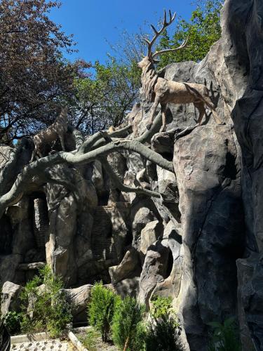 a statue of a deer on a rocky mountain at Luxury Residence Likani in Borjomi