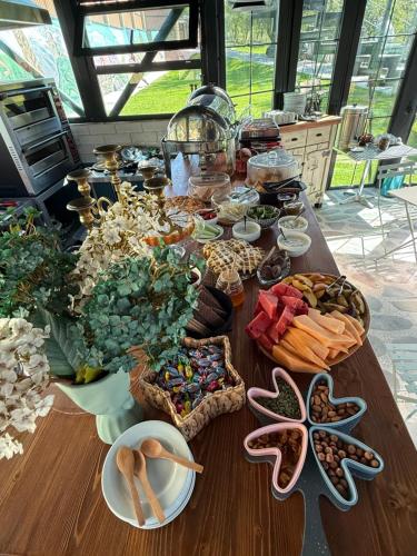 a table topped with plates and bowls of food at SaguleResort in Monasteri