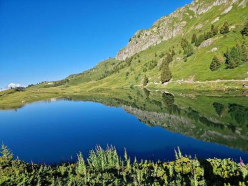 a reflection of a mountain in a lake at Charming Chalet Near Trails in Mörel