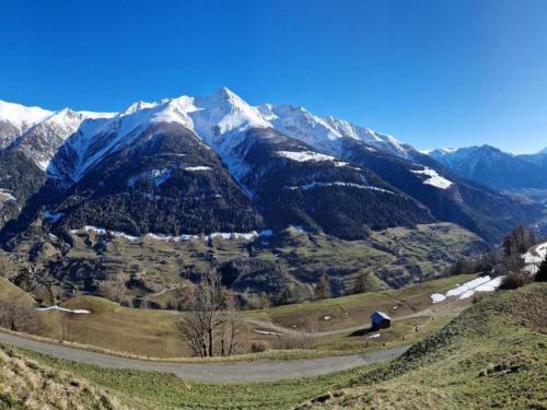 a view of a mountain range with snow covered mountains at Charming Chalet Near Trails in Mörel