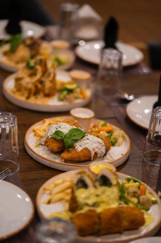 a wooden table with plates of food on it at Khar Hotel in Skardu