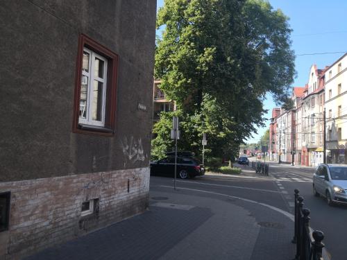 a building with a window on the side of a street at Grottgera Inn Bytom in Bytom