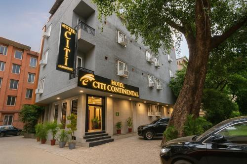 a building with a sign that reads hotel cm convention at Hotel Citi Continental in New Delhi