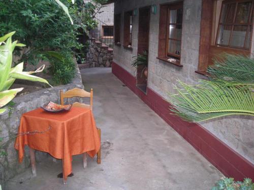 a table and chairs with a orange table cloth on it at B&B L'Arcobaleno in Sorrento
