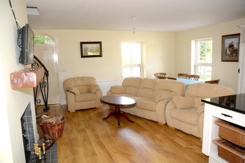 a living room with a couch and a table at The Gate Lodge Cannaway House in Macroom