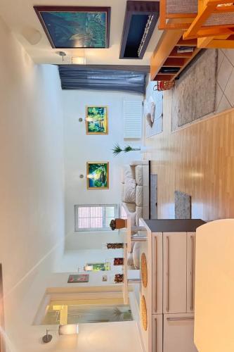 a room with a kitchen and a living room with a ceiling at DioApartia in Brno