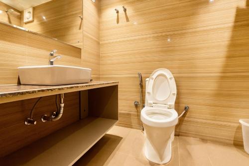 a bathroom with a white toilet and a sink at Hotel Citi Continental in New Delhi