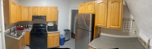a kitchen with wooden cabinets and a stainless steel refrigerator at The Peppermint in Mount Vernon
