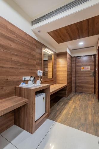 a bathroom with wooden walls and a sink at Hotel Highway King Bilaspur in Gurgaon