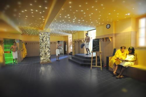 a group of people sitting in a kitchen in a room at Hotel Eifelsteig in Roetgen