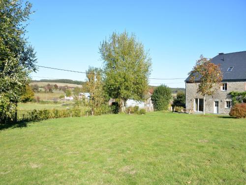 a large grassy yard in front of a house at Holiday home in Gedinne with forest in Gedinne