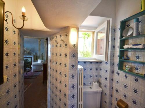 a bathroom with a toilet and a window at Romantic Getaway with Views in Montecastelli Pisano