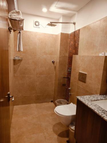 a bathroom with a toilet and a shower at Mohor Kutir Resorts in Bolpur