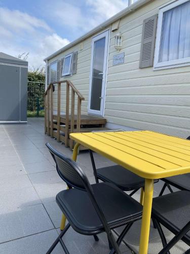 a yellow table and chairs on a patio at Havana De Luxe Bredene in Bredene