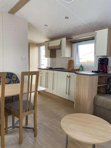a small kitchen and dining area of a caravan at Havana De Luxe Bredene in Bredene