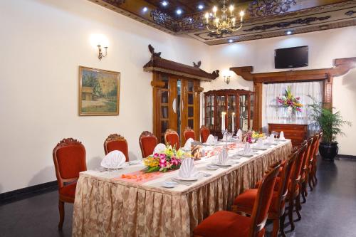 a conference room with a long table and chairs at Hotel Continental Saigon in Ho Chi Minh City