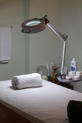 a lamp with a white towel sitting on a bed at Pontalmar Praia Hotel in Natal