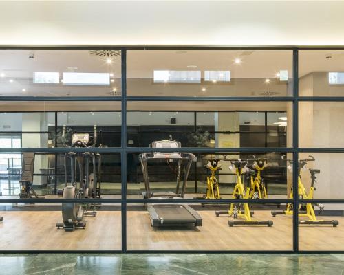 a gym with several exercise equipment in a building at Ilunion Pio XII in Madrid
