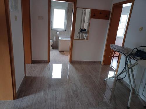 a room with a hallway with a sink and a mirror at Apartmani Ernesta in Selce