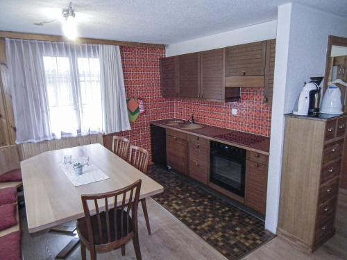 a kitchen with a table and a dining room at Chalet in Lenk near Simmen Falls in Lenk