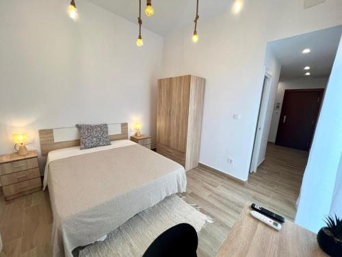a bedroom with a bed and two night stands and lights at Thor Hostal Boutique in Alicante