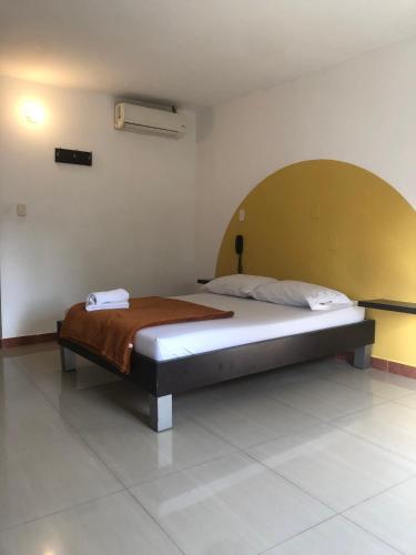a bedroom with a bed in a room at Hotel Cielo de Tambores in Cali