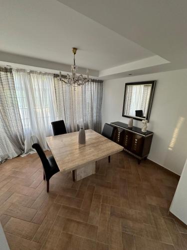 a dining room with a wooden table and chairs at Modern house in Larnaca in Larnaka