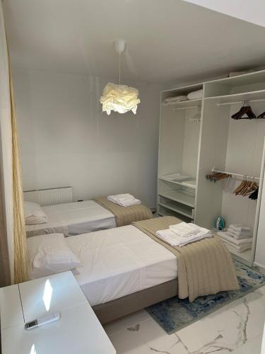 a bedroom with two beds and a mirror at Modern house in Larnaca in Larnaka