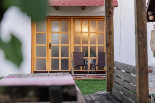 a patio with a table and chairs in front of a door at Hillside Apartment Kruna in Babušnica