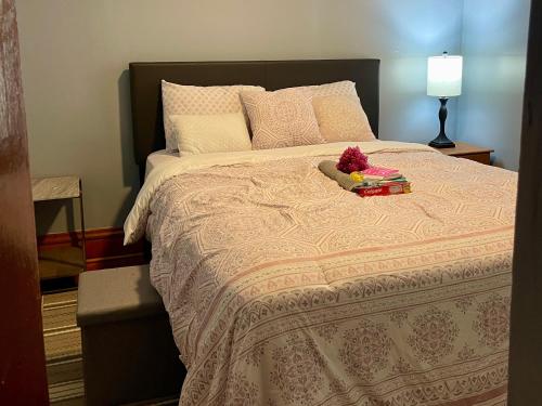 a bedroom with a large bed with a book on it at Fully Furnished 2BR Apartment Near Oak Park I Utilities Included I Car Rental Available in Chicago