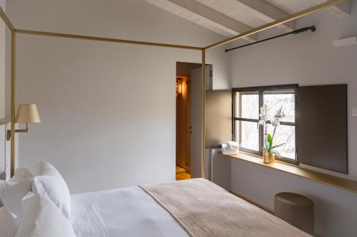 a bedroom with a bed and a window at Palazzo Zimara Boutique Hotel in Lecce