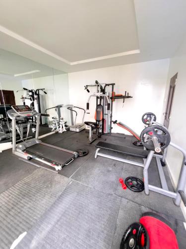 a gym with several exercise equipment in a room at Mba suites in Lekki