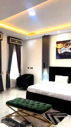 a bedroom with a bed and a couch in a room at Mba suites in Lekki