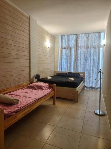 two beds in a room with a window at Gold Bugaz in Odesa