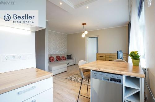 a kitchen and living room with a table and chairs at Riverside Apartment Pärnu in Pärnu