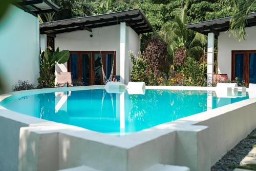 a swimming pool in front of a house at Bamboo Surf Beach in San Isidro