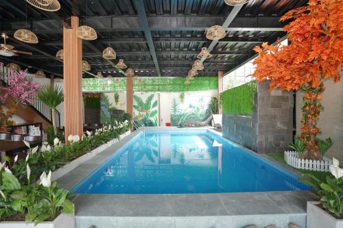 a swimming pool in a building with plants at Tam Coc Morning Homestay & Spa Ninh Binh in Vũ Lâm