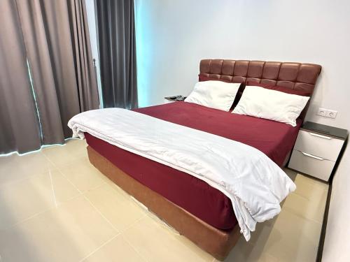 a bedroom with a large bed with a brown headboard at 1 BR Comfy & Premium Entire Apt By Deeta Living in Jakarta