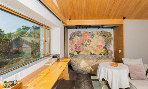 a room with a bed and a large window at 北京一瓢客栈 Beijing YiPiao Inn in Beijing