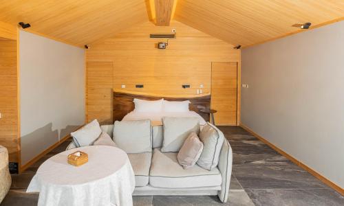 a bedroom with a bed and a couch and a table at 北京一瓢客栈 Beijing YiPiao Inn in Beijing