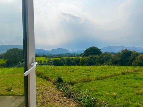 a view from a window of a green field at Cillarney Lakeview Loft Apartment in Killarney