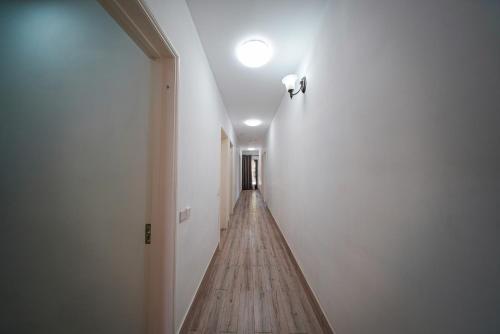 a hallway with a wooden floor and a light on the ceiling at Allee coco in Trou aux Biches